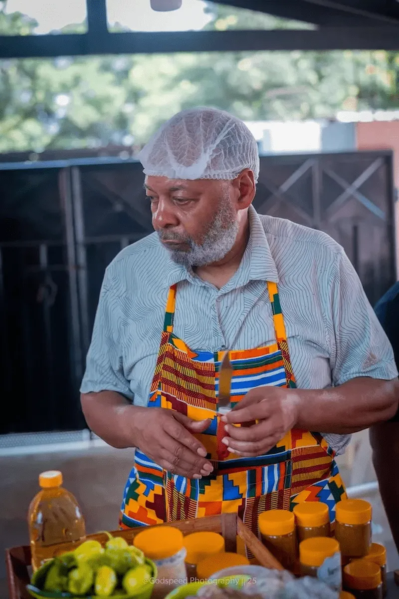 A traveler prepares fresh ingredients during a BookAfrica Cooking Class.