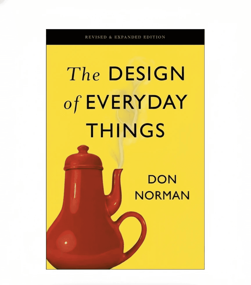 Stacked glass cube with layered translucent liquid on a concrete floor—minimal studio sculpture against a white wall.