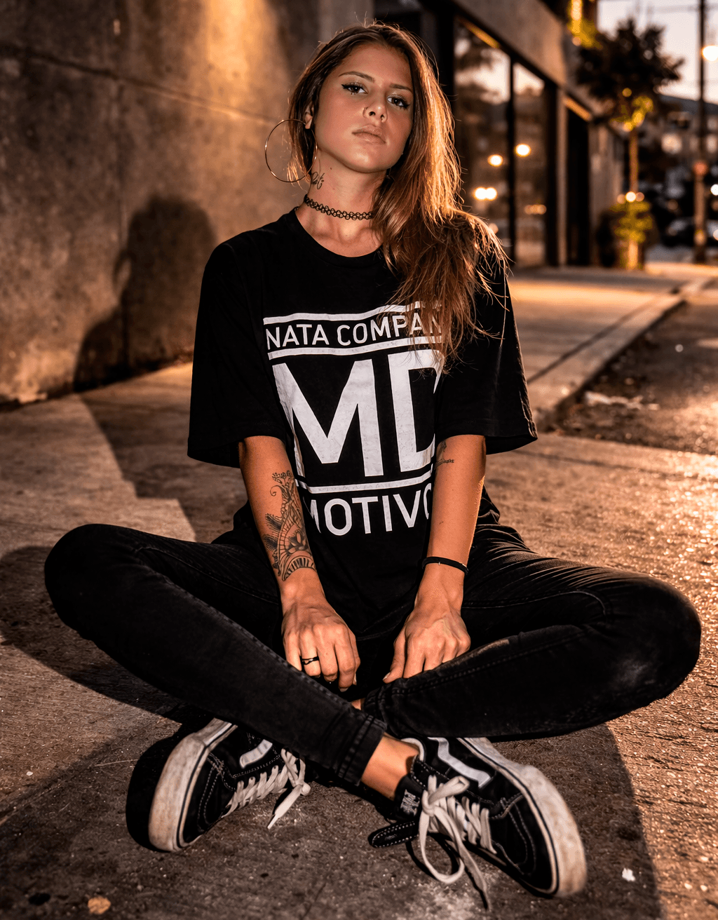 Close-up of stylish women’s chunky sneakers in soft green, beige, and orange tones, worn by a woman indoors with bright natural lighting.