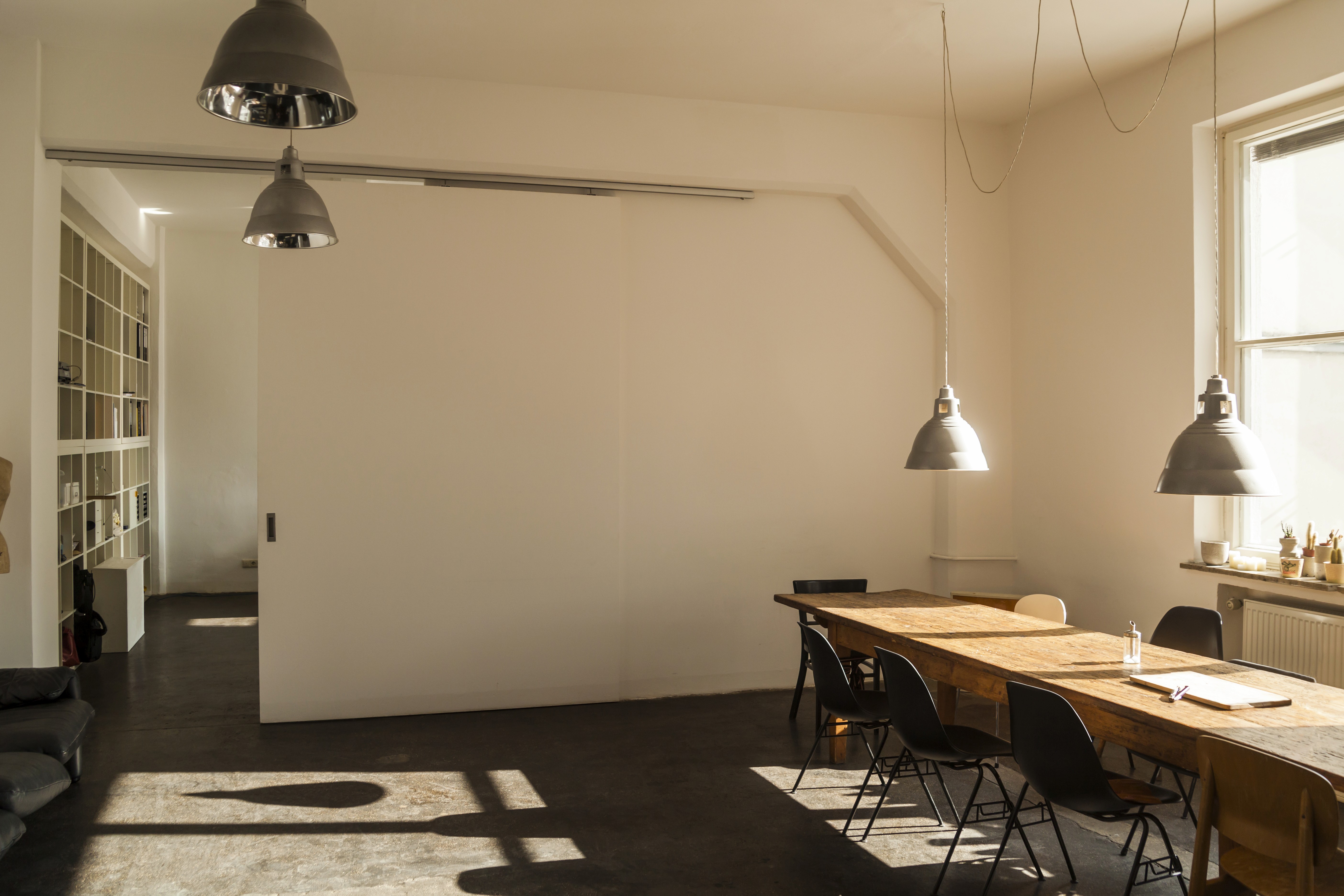 Terracotta stucco space with intersecting arches and warm sunlight creating geometric shadows.
