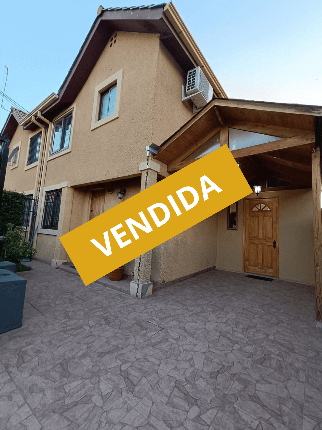 Rustic wooden cabin homes on a forested, rocky hillside road.