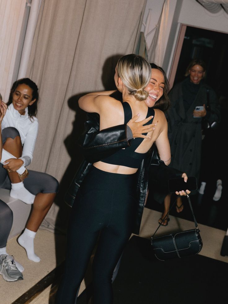 Two women hugging at a studio event