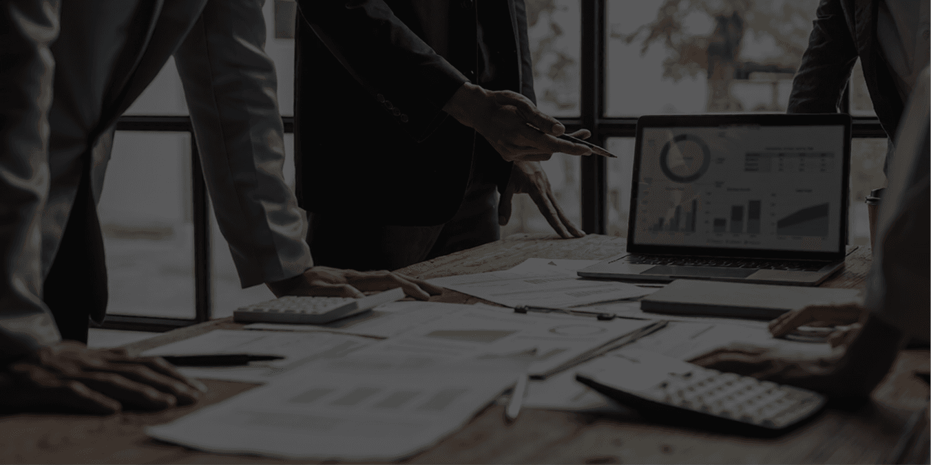 Professional Power BI consulting team presenting enterprise analytics dashboards and business intelligence reports during a corporate strategy meeting in a modern office conference room.