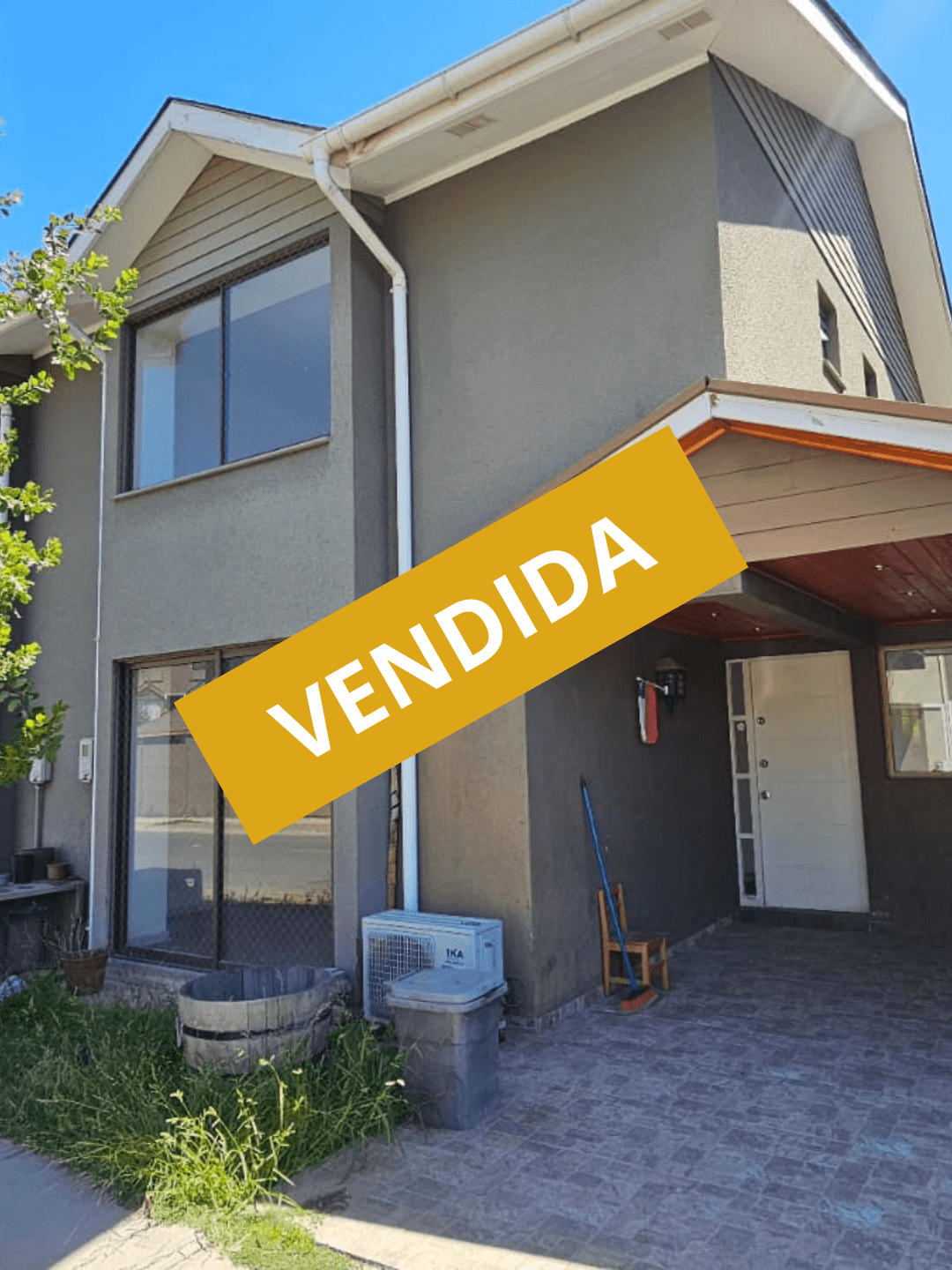 Suburban house with a two-car garage at twilight after a rain shower.