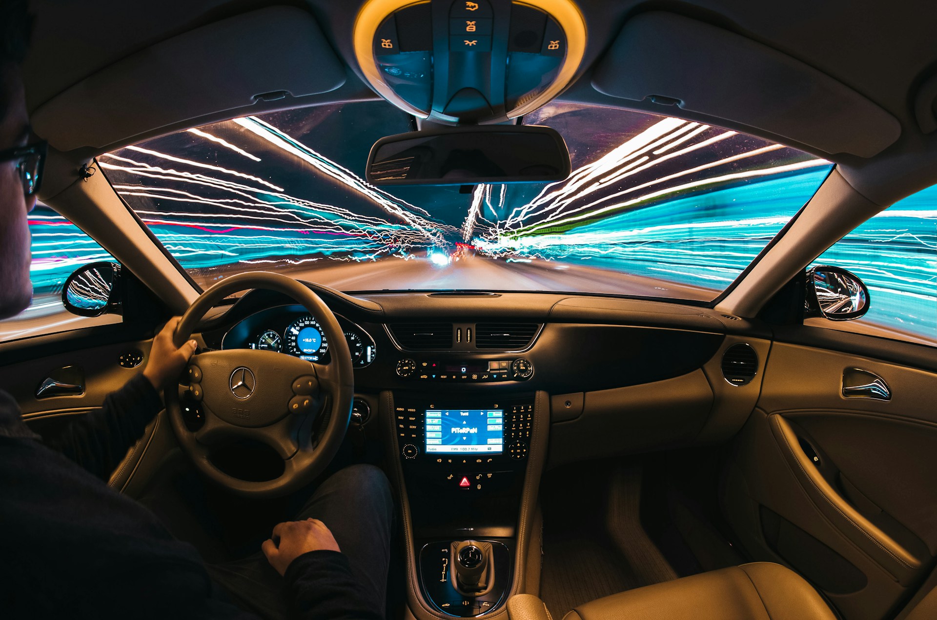 interior view of car with motion lights long exposure light blur outside the windows