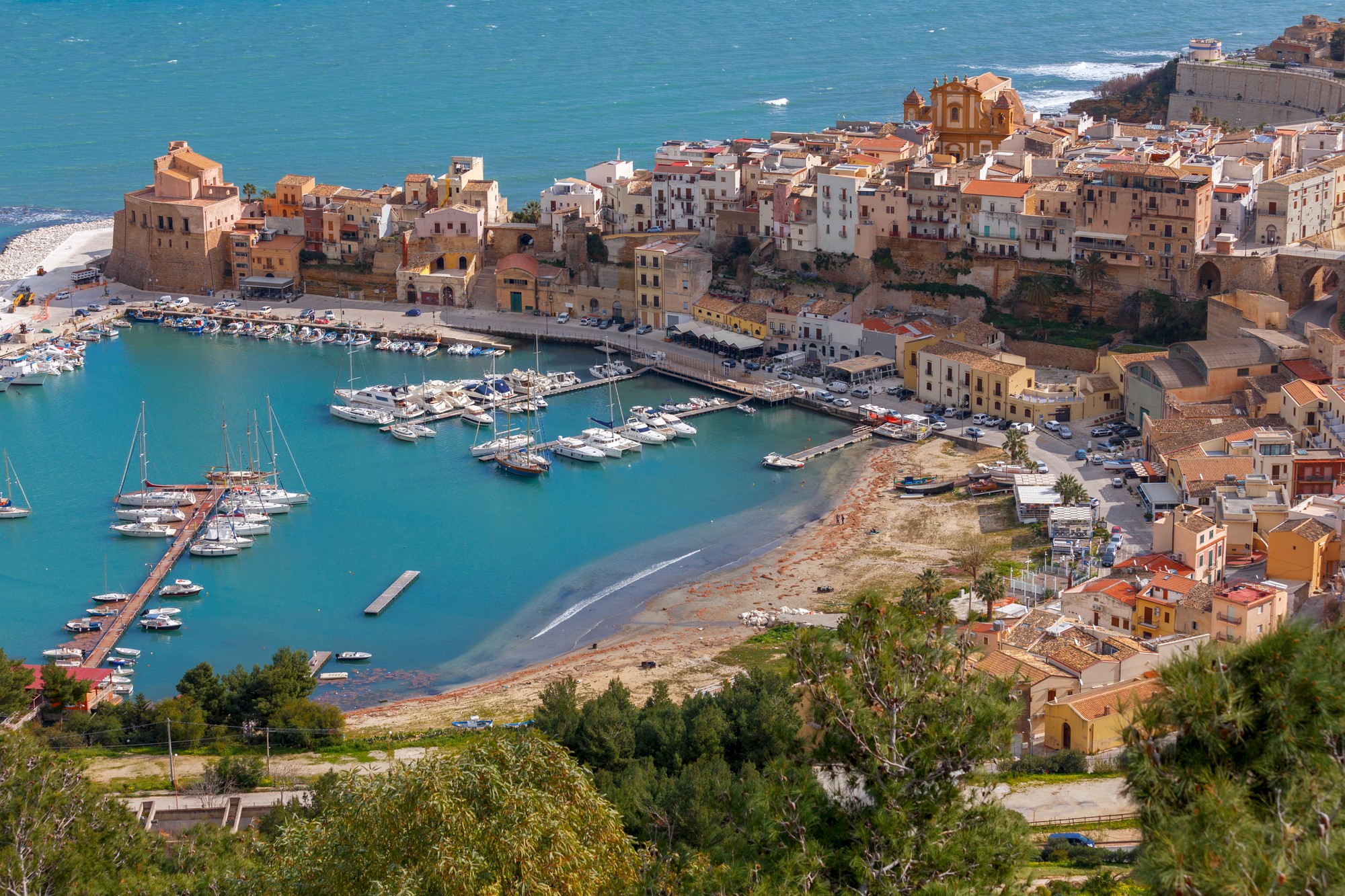 brown wooden beach lounge chair on beach during daytime