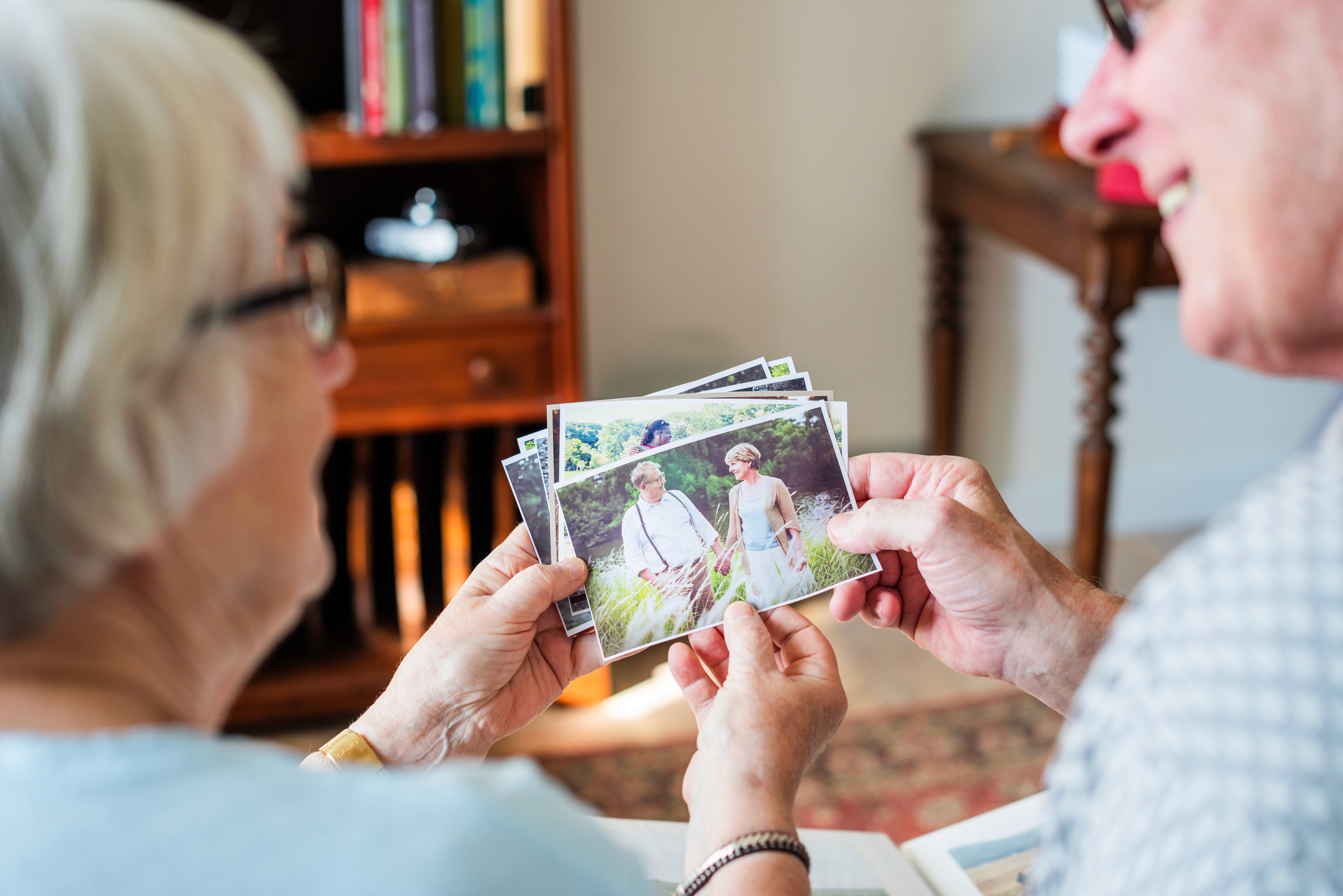 elderly-couple-looking-old-photos-reminiscing-couple-enjoys-memories-sharing-stories-photos-bring-nostalgia-connection-elderly-pair-elderly-couple-looking-photos-care-home.jpg