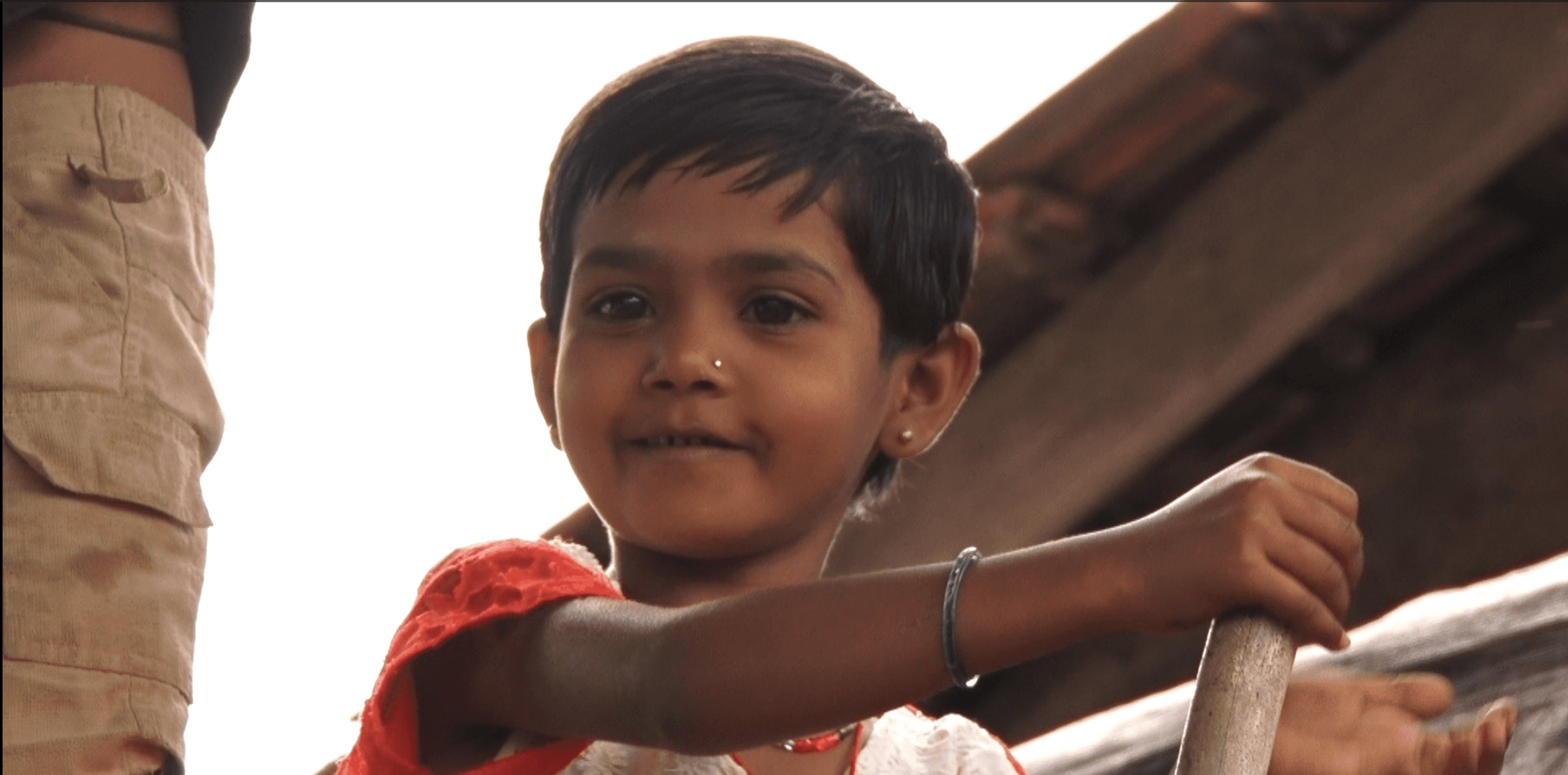 a woman holding a red flower