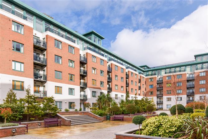 Adelaide Square Apartments – A curved, red-brick residential complex with large windows.