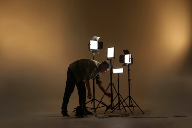 Videographer setting up a shot beside a tripod