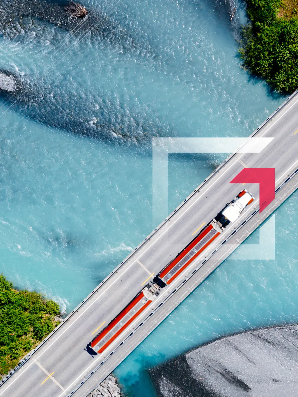 Aerial view of a semi-truck driving across a bridge over blue water representing commercial truck insurance services by GIA Group, LLC