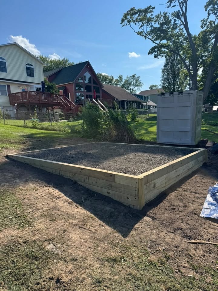 Finished gravel shed pad framed with timber on a residential lot in Onondaga County, NY