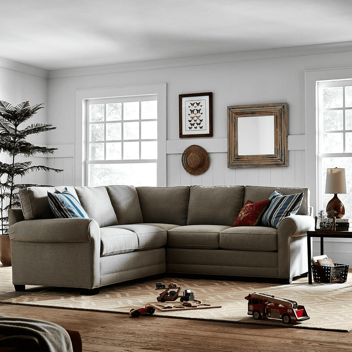 Gray Stone & Beam Kristin performance fabric sectional sofa in a family-friendly living room with toys on the floor