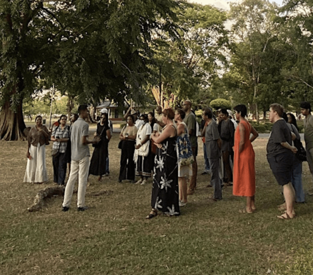 a group of women standing on top of a sandy beach