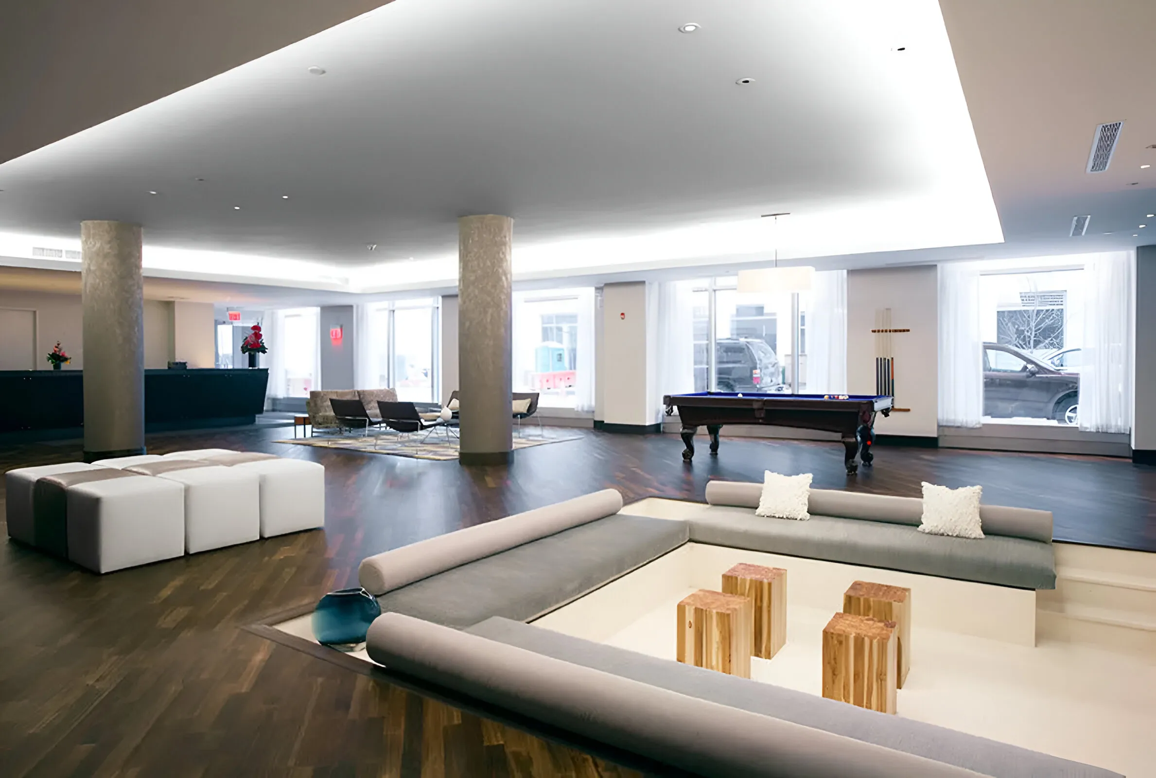 A modern hotel lobby featuring a stylish pool table and contemporary furnishings.