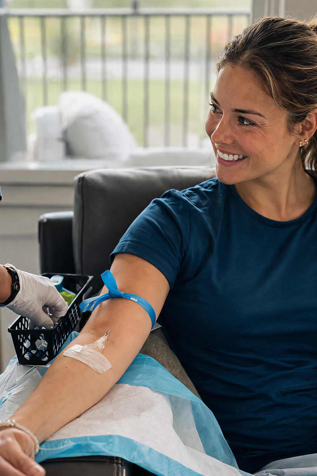 Smiling woman having blood drawn from her arm.
