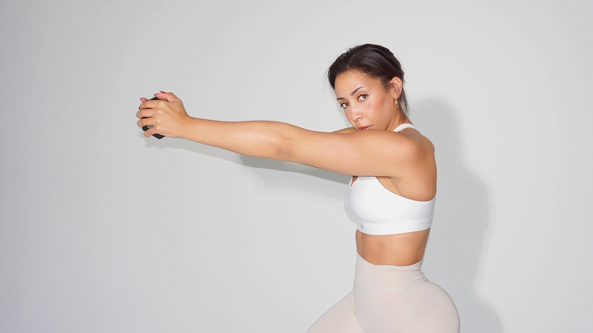Arm reach stretch in the Intisar Fitness studio