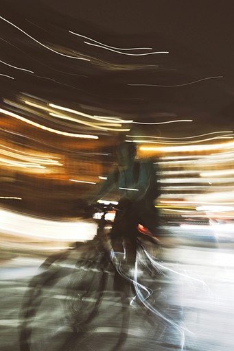 Abstract motion blur of a cyclist at night