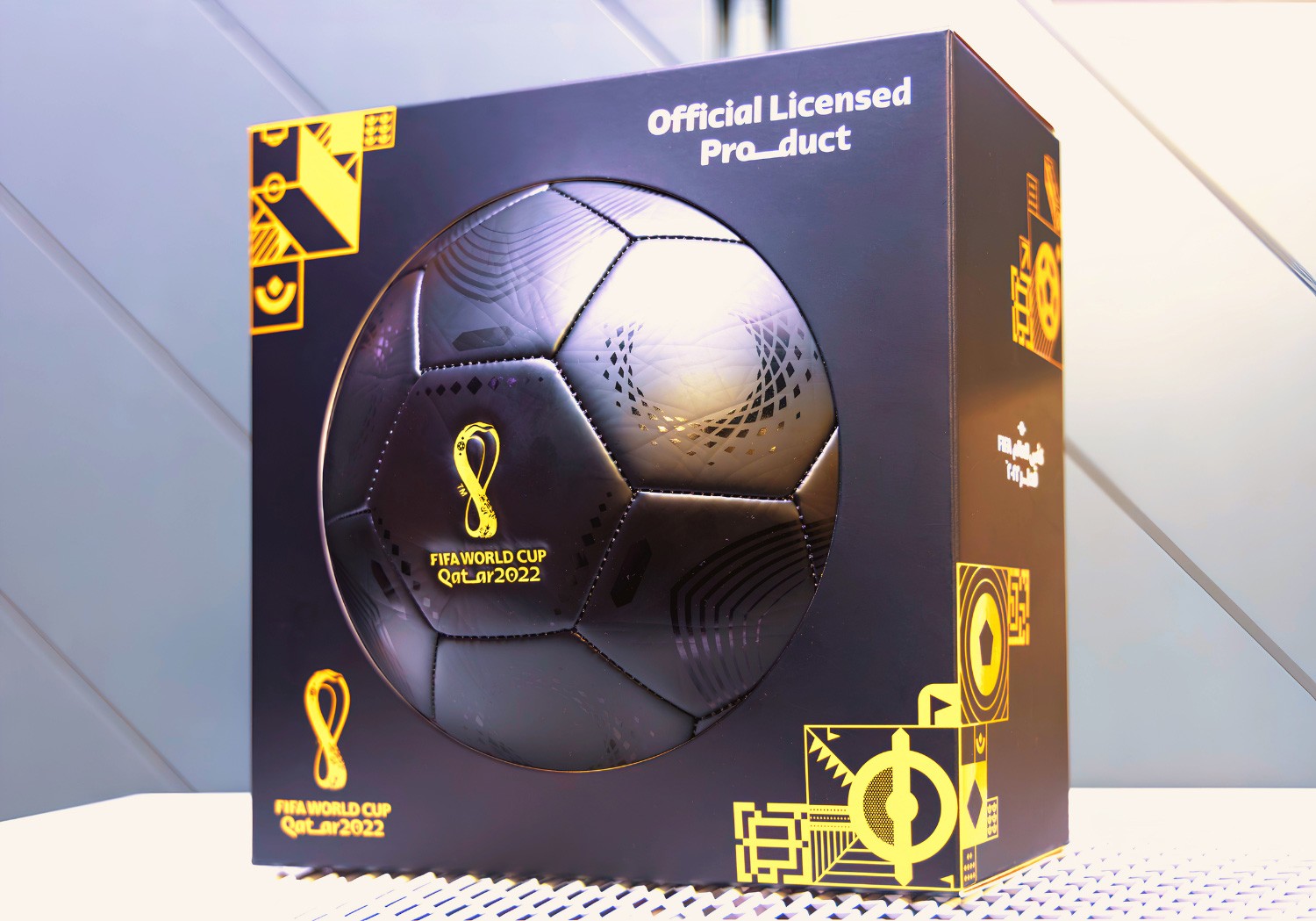 The FIFA World Cup 2022 Premium Ball packaging: a black box with a window showing the match ball, gold mosaic graphics and "Official Licensed Product."