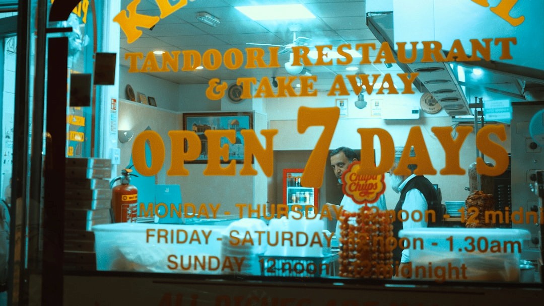 Tandoori restaurant window with open 7 days sign