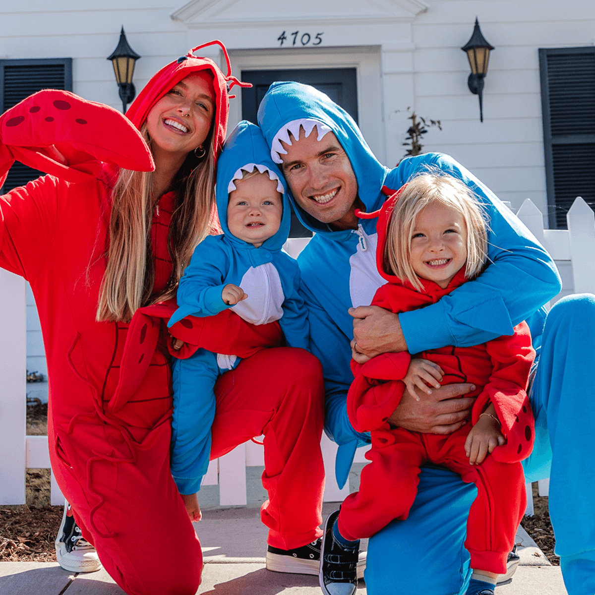 Family wearing colorful lobster and shark costumes