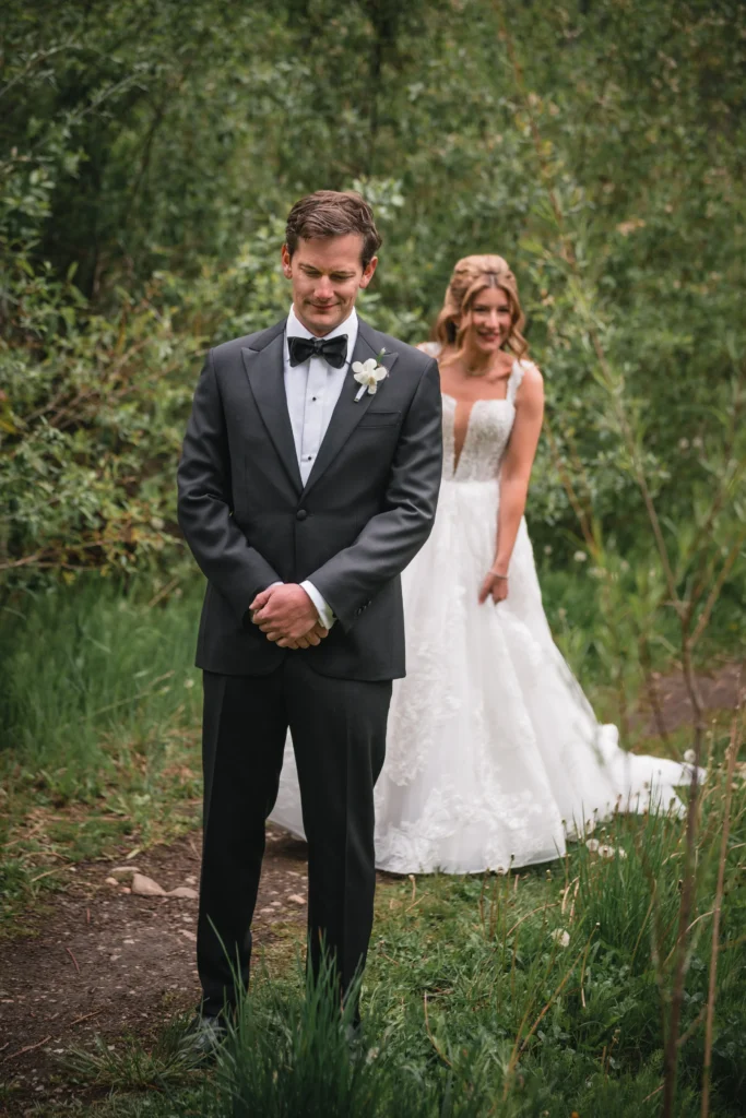 Groom waiting during first look in nature at Aspen Meadows Resort Wedding