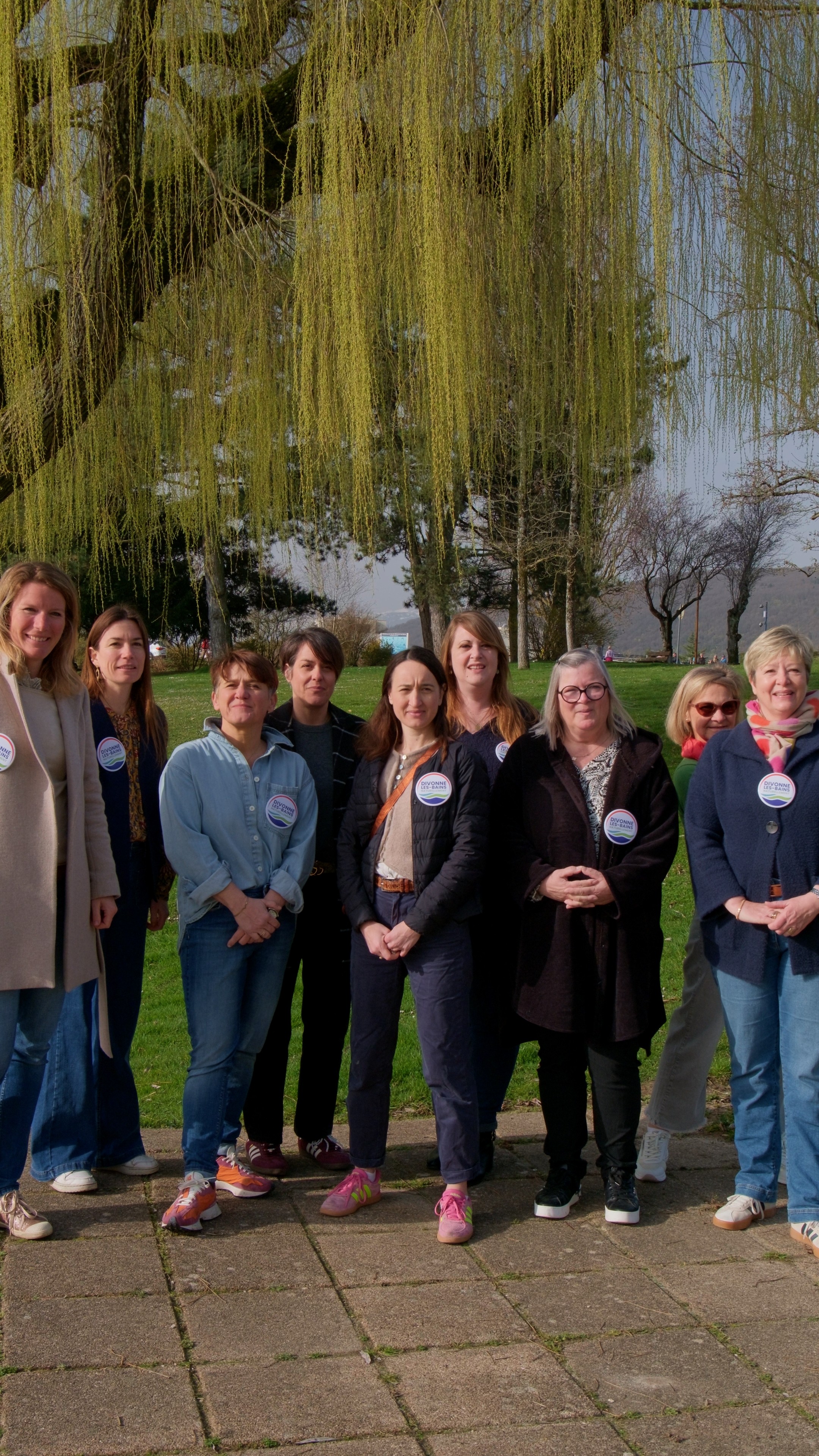 Modern living room with red sofa and grey chairs.