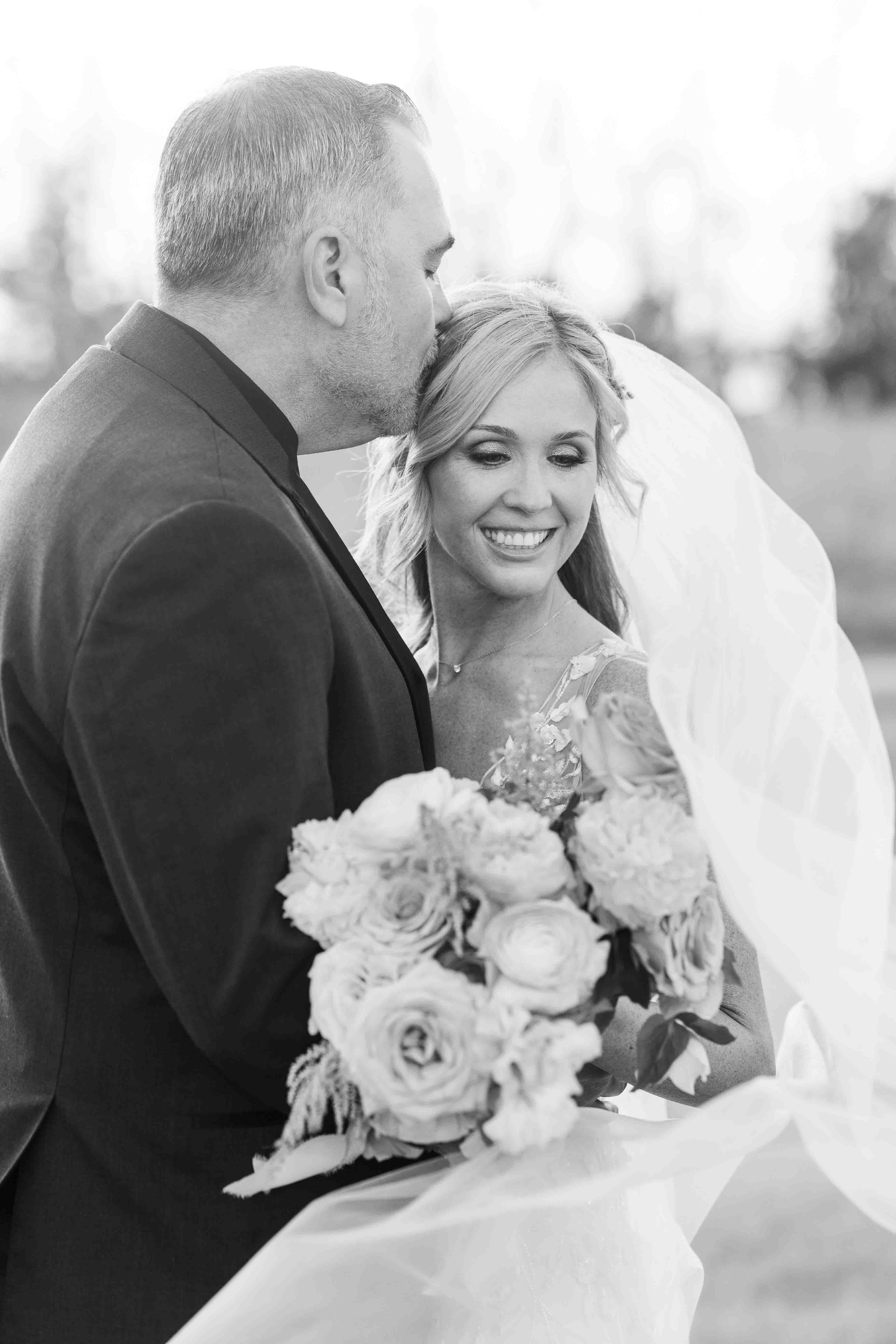 Bride and groom Nashville Tennessee wedding portrait under willow tree during sunset on golf course. 