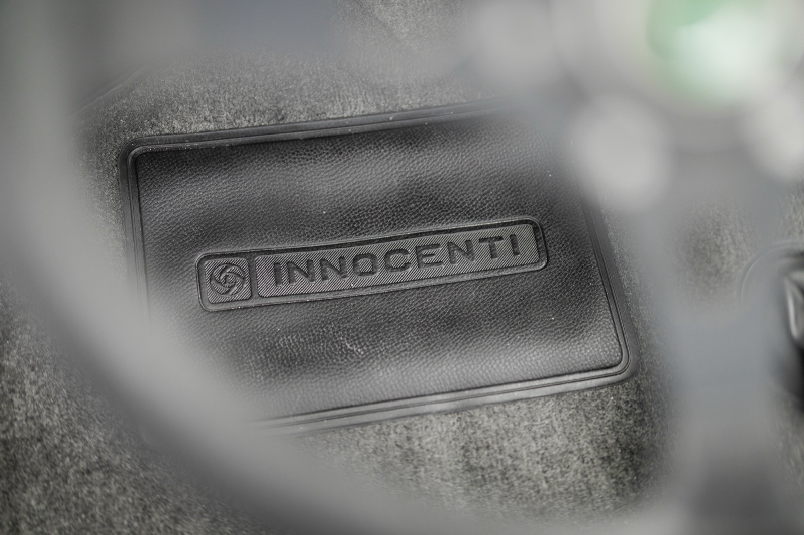 Close-up of an object with a textured surface, possibly part of a device, with a blurry background.
