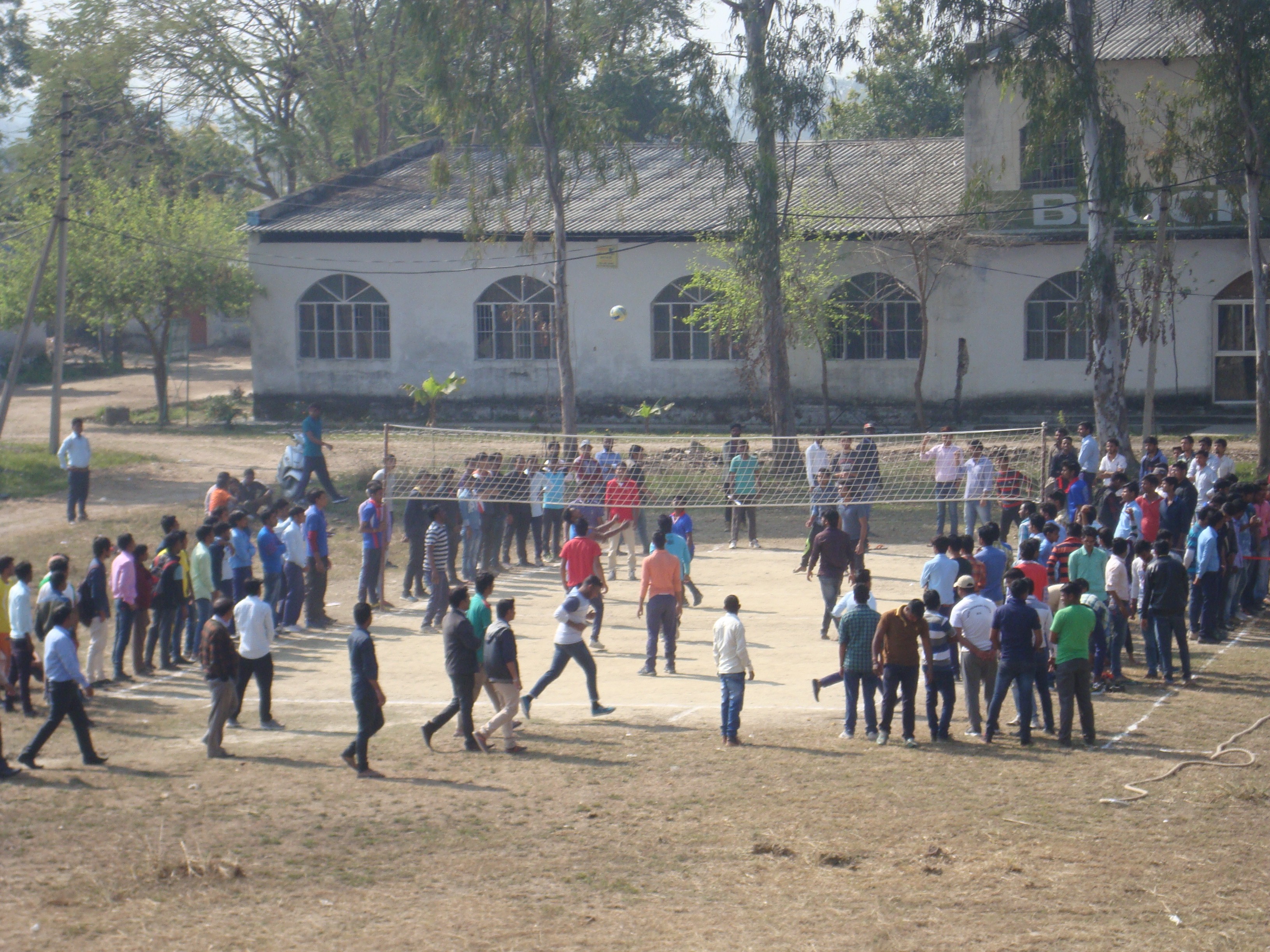 man standing in front of people sitting beside table with laptop computers