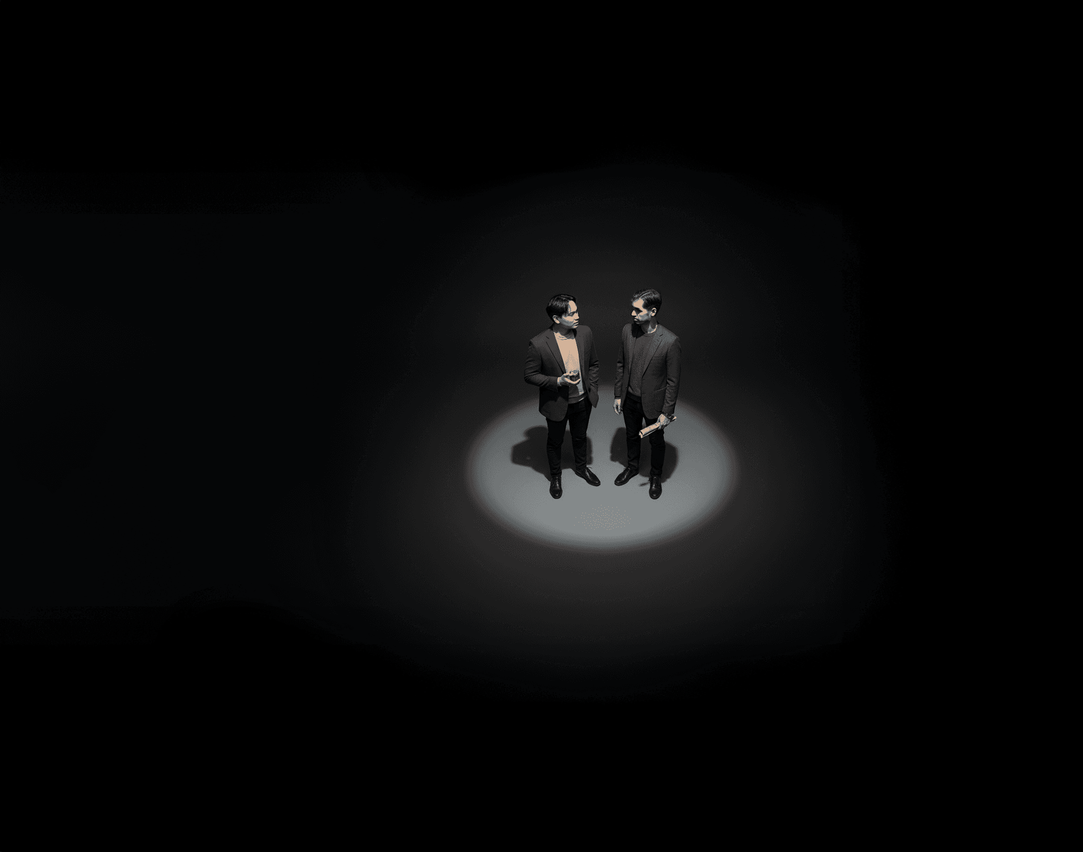 Tree branches reach towards a clear, blue sky.