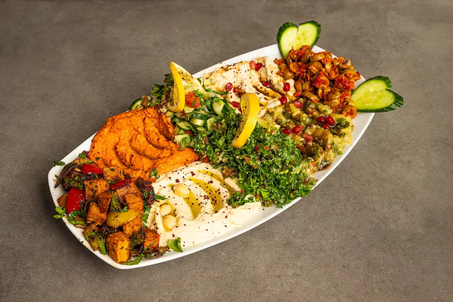 A gourmet dish featuring a thick cut of steak served with roasted cauliflower,