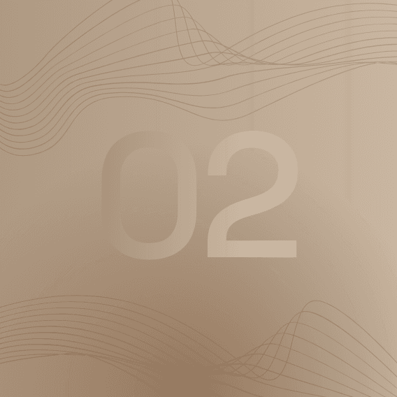 A focused woman with long red hair is seated at a desk, wearing a black blazer and dark blouse. She intently looks at camera, smiling slightly, with an open laptop in front of her. The setting is a warm and serene office setup in the background. Soft daylight filters through, creating a calm atmosphere. The composition captures her in a frontal profile with a clear emphasis on her concentration and the serene indoor setting.