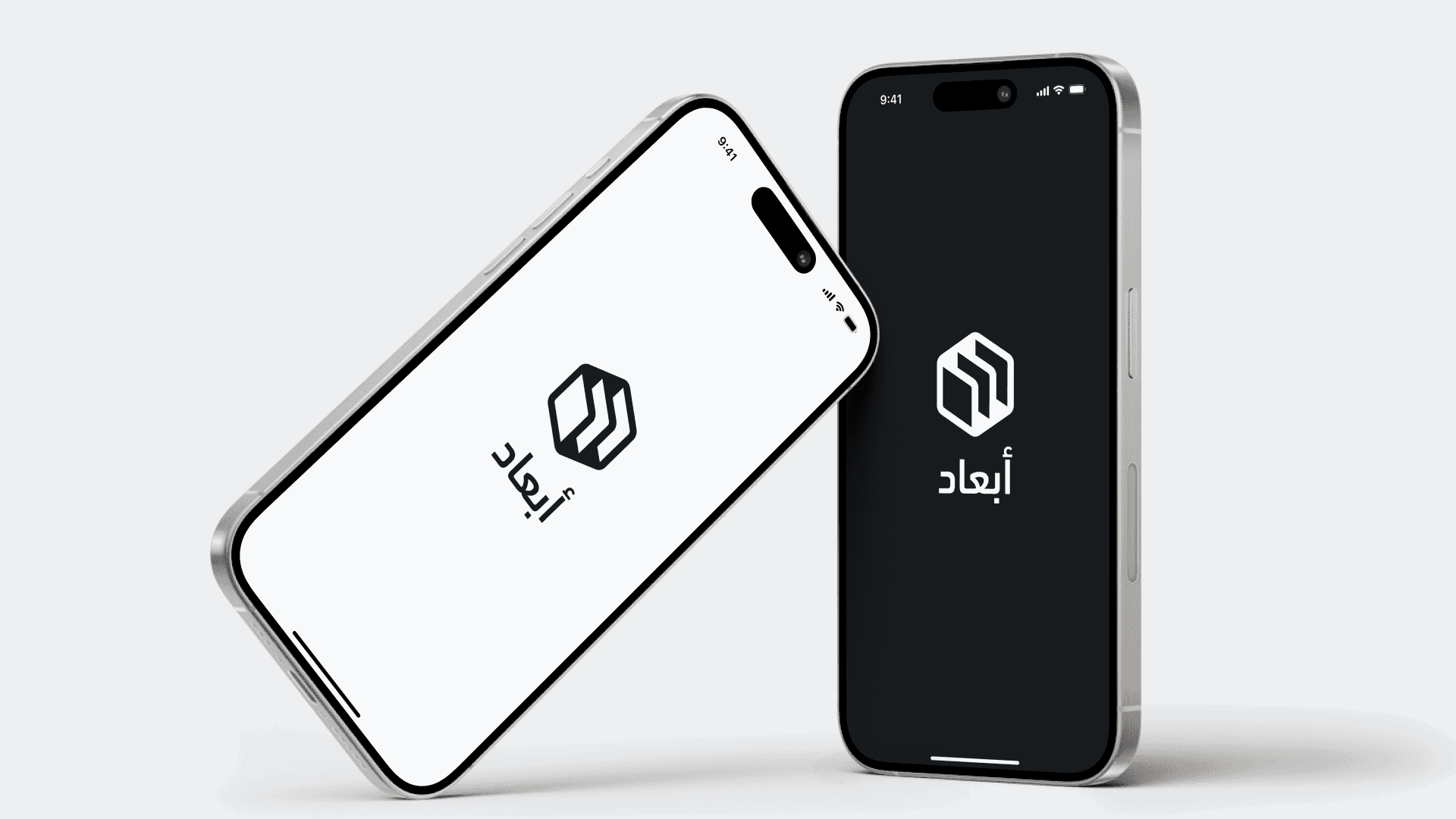 Two smartphones, one white and one black, leaning against each other with a logo of abaad displayed on their screens.