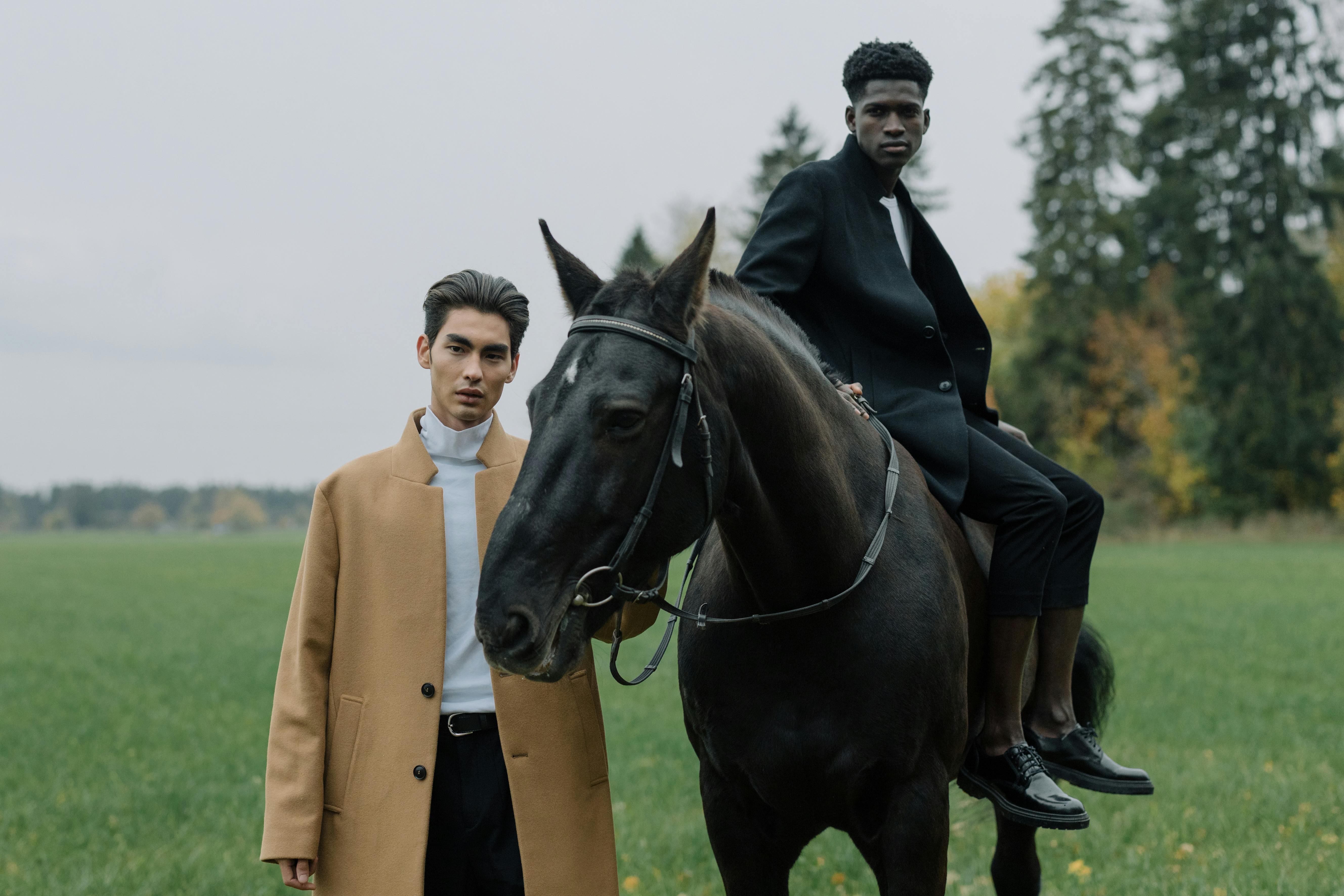 Man on a horse with a friend in a field