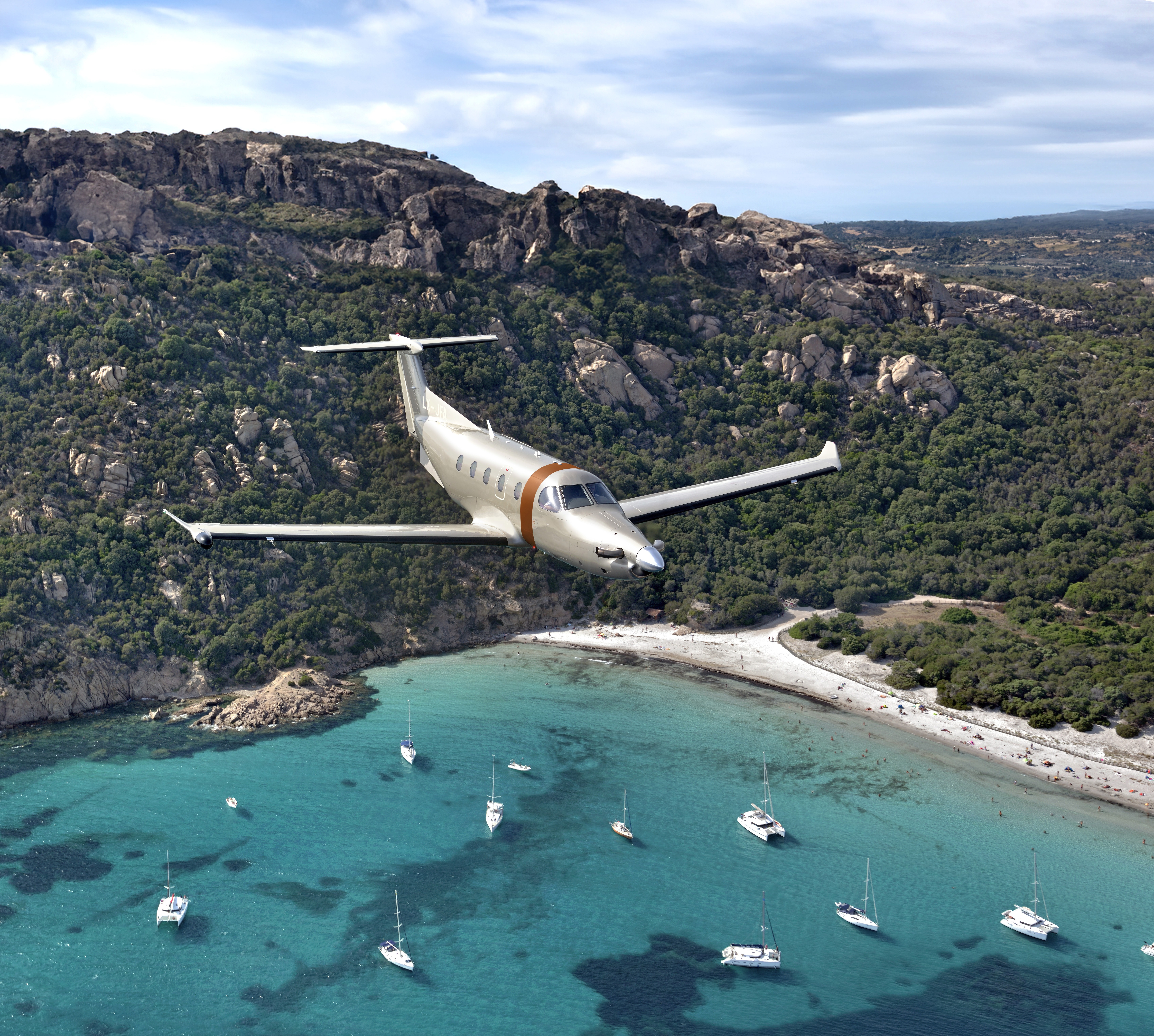 Pilatus PC-12 flying over the sea.