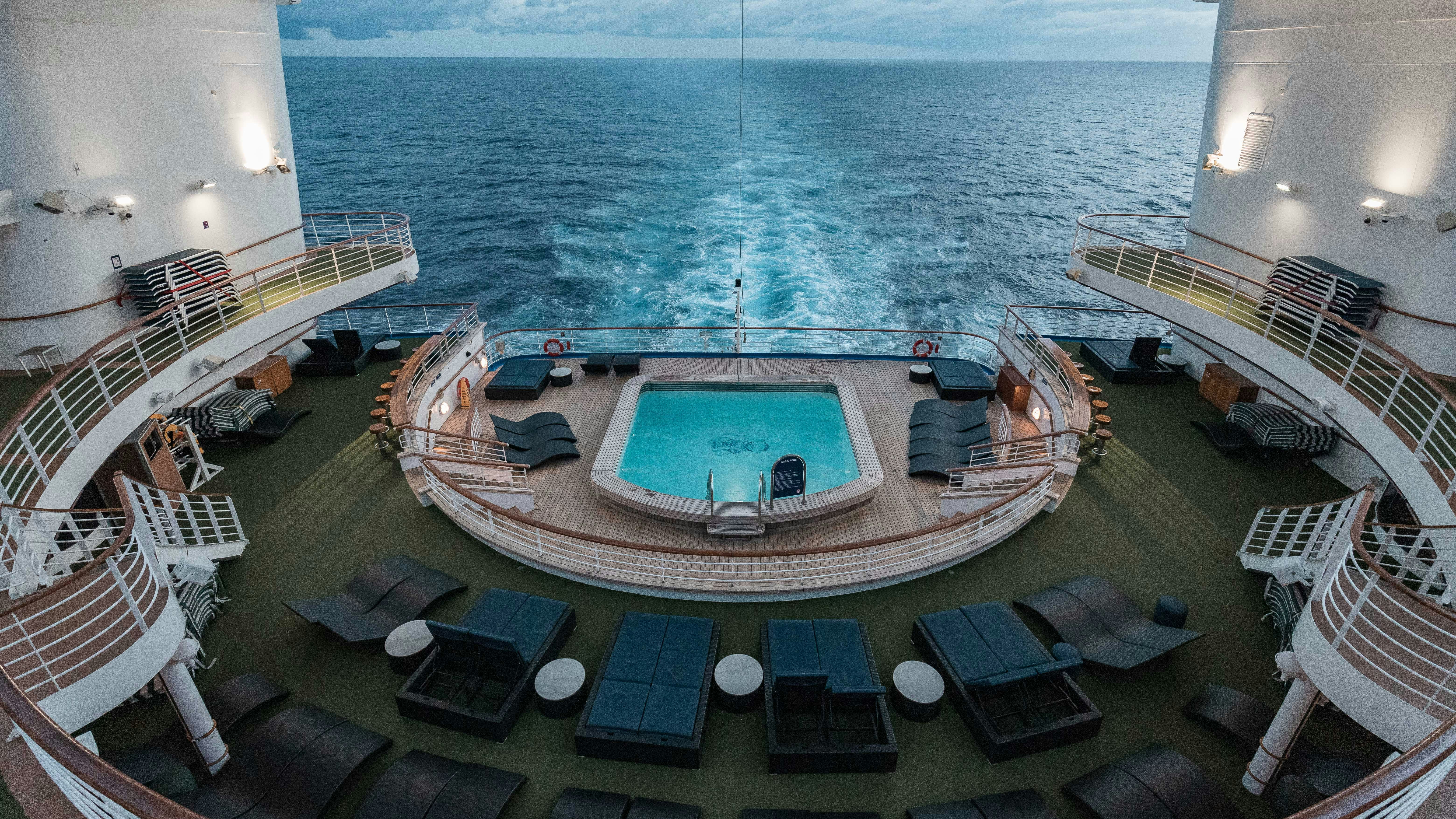 An aft pool deck with loungers and a whirlpool.
