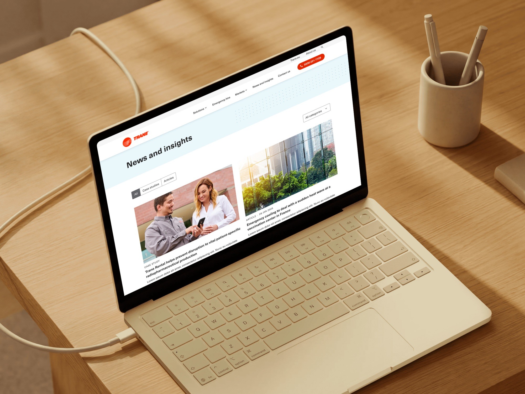 Trane rental News and insights page on a laptop, with filter tabs and two featured stories