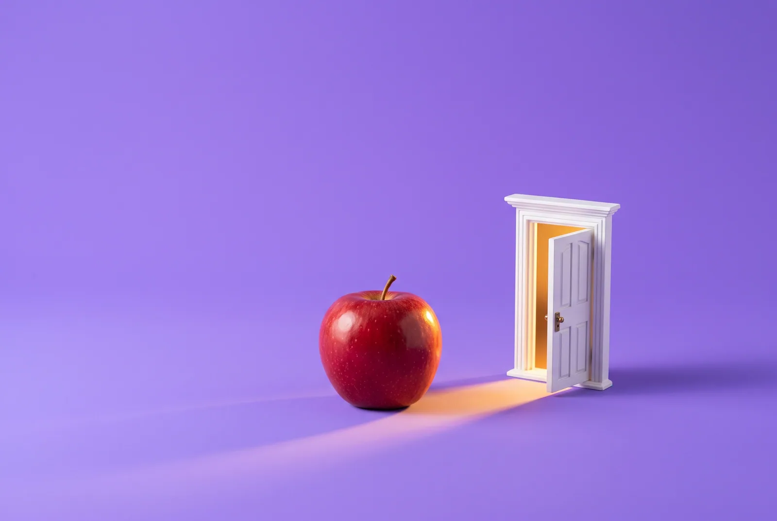 A red apple before a small open doorway full of warm light, what makes the best Christian app to quit porn: a way out