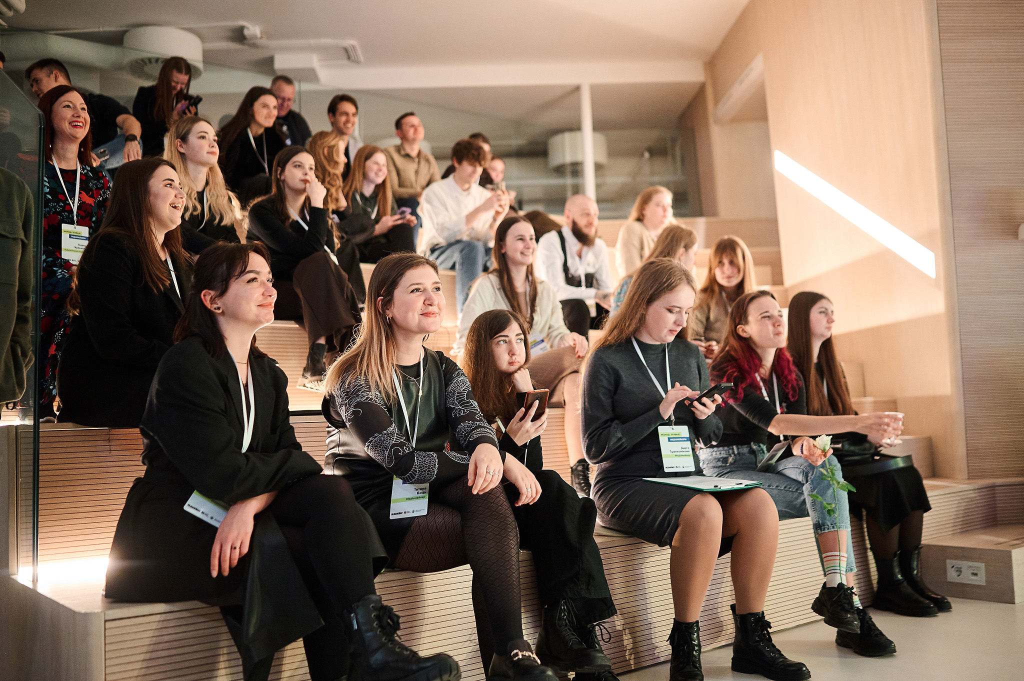 Attendees at an AI conference listening attentively to a speaker during a session on real-world artificial intelligence applications.