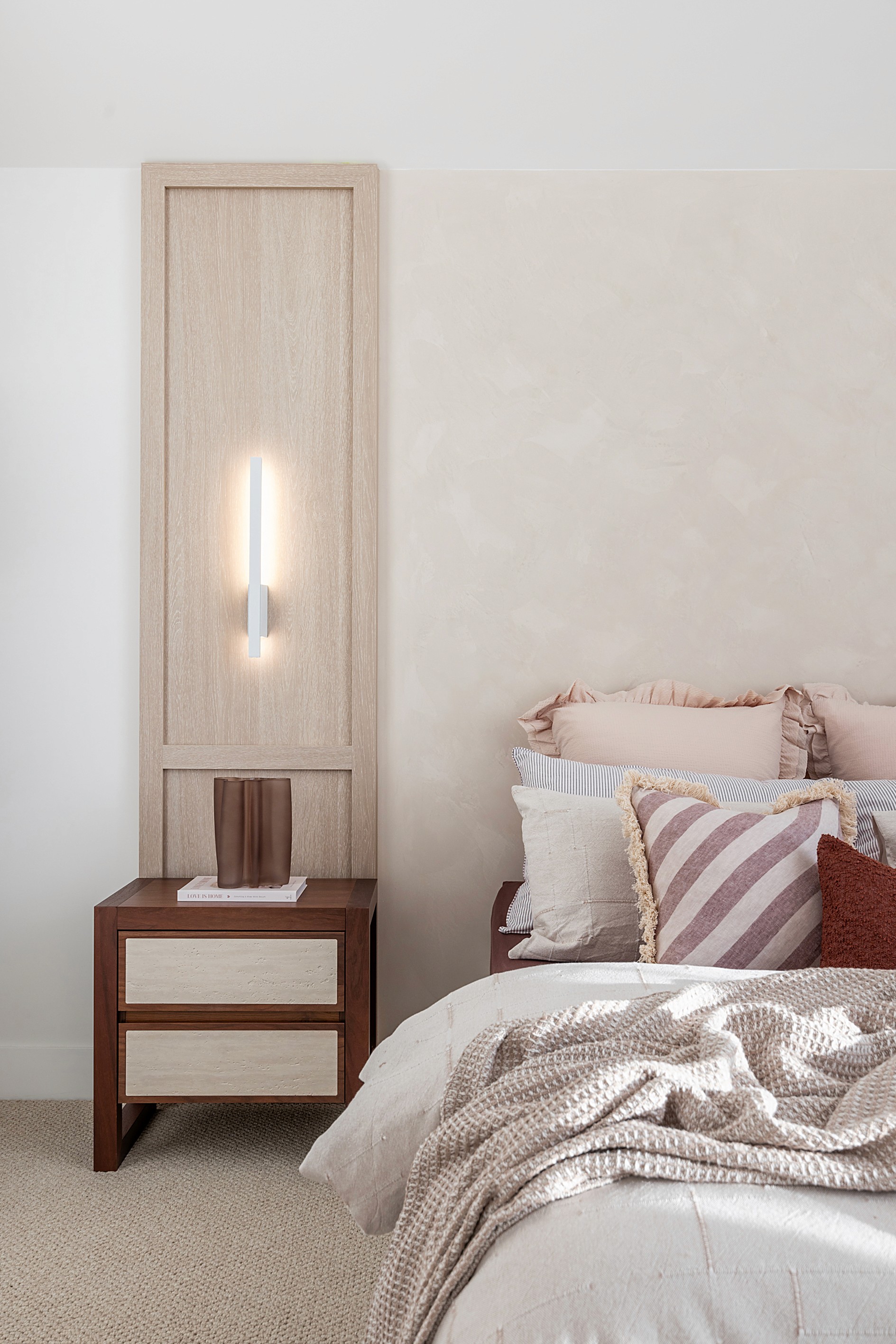 Modern swimming pool with lush green plants and flowers.