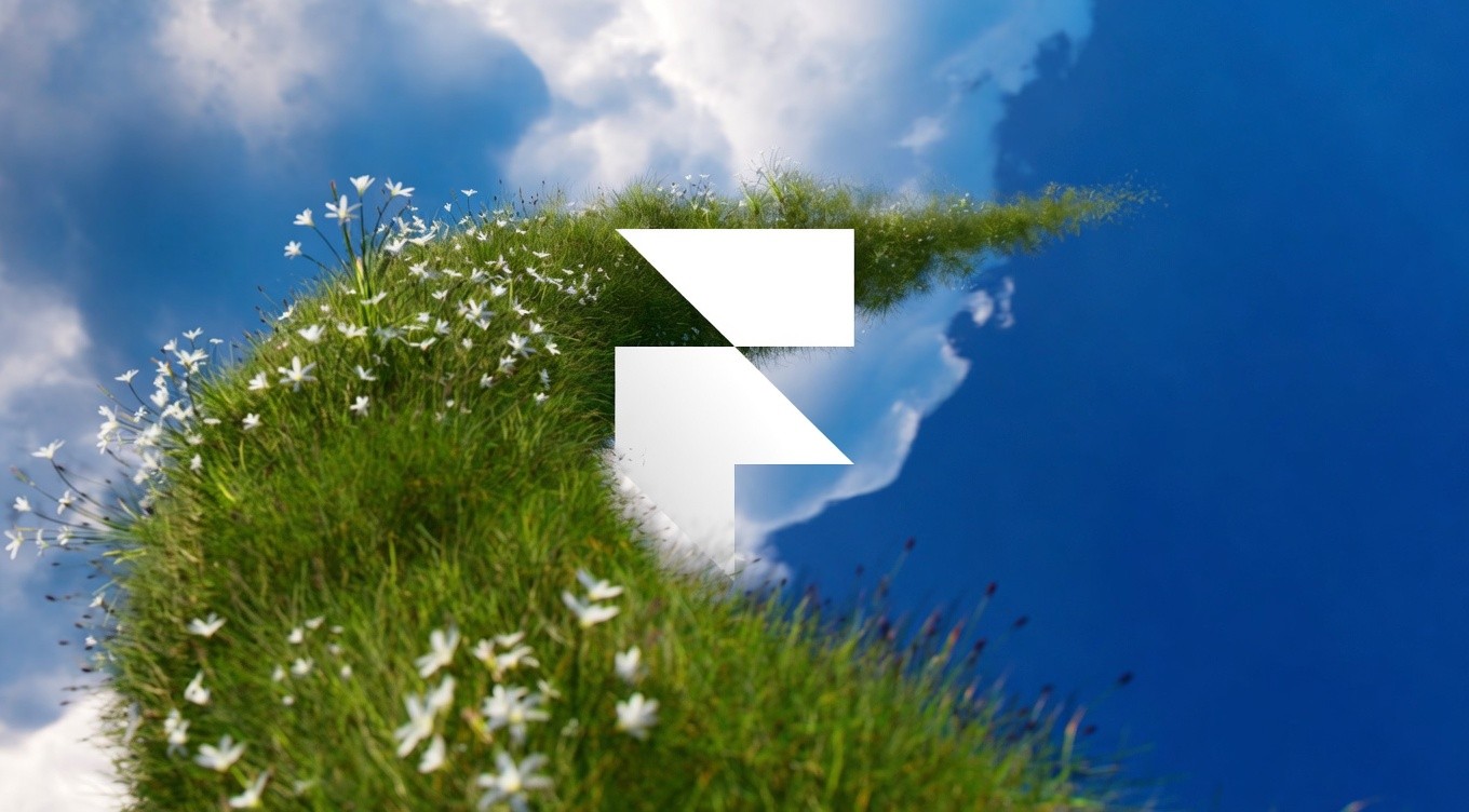 A vibrant blue sky with fluffy clouds reflects in water, while a grassy shoreline adorned with white flowers curves inwards. An abstract white logo overlays.