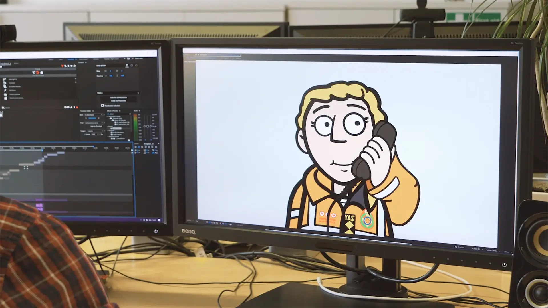 An animator working on an illustrated Yorkshire Air Ambulance character displayed on a computer screen.