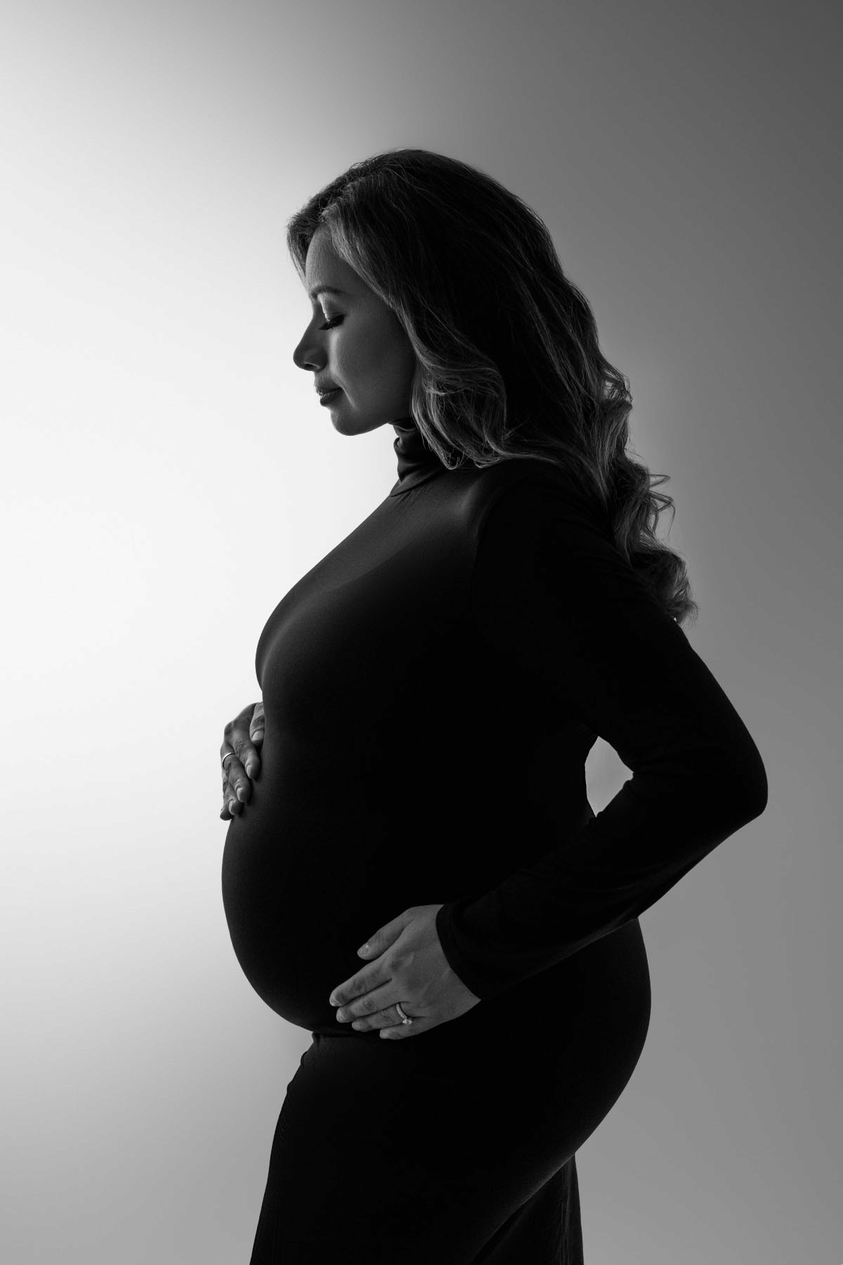 Expecting mom in simple fitted dress — timeless and modern maternity portrait.