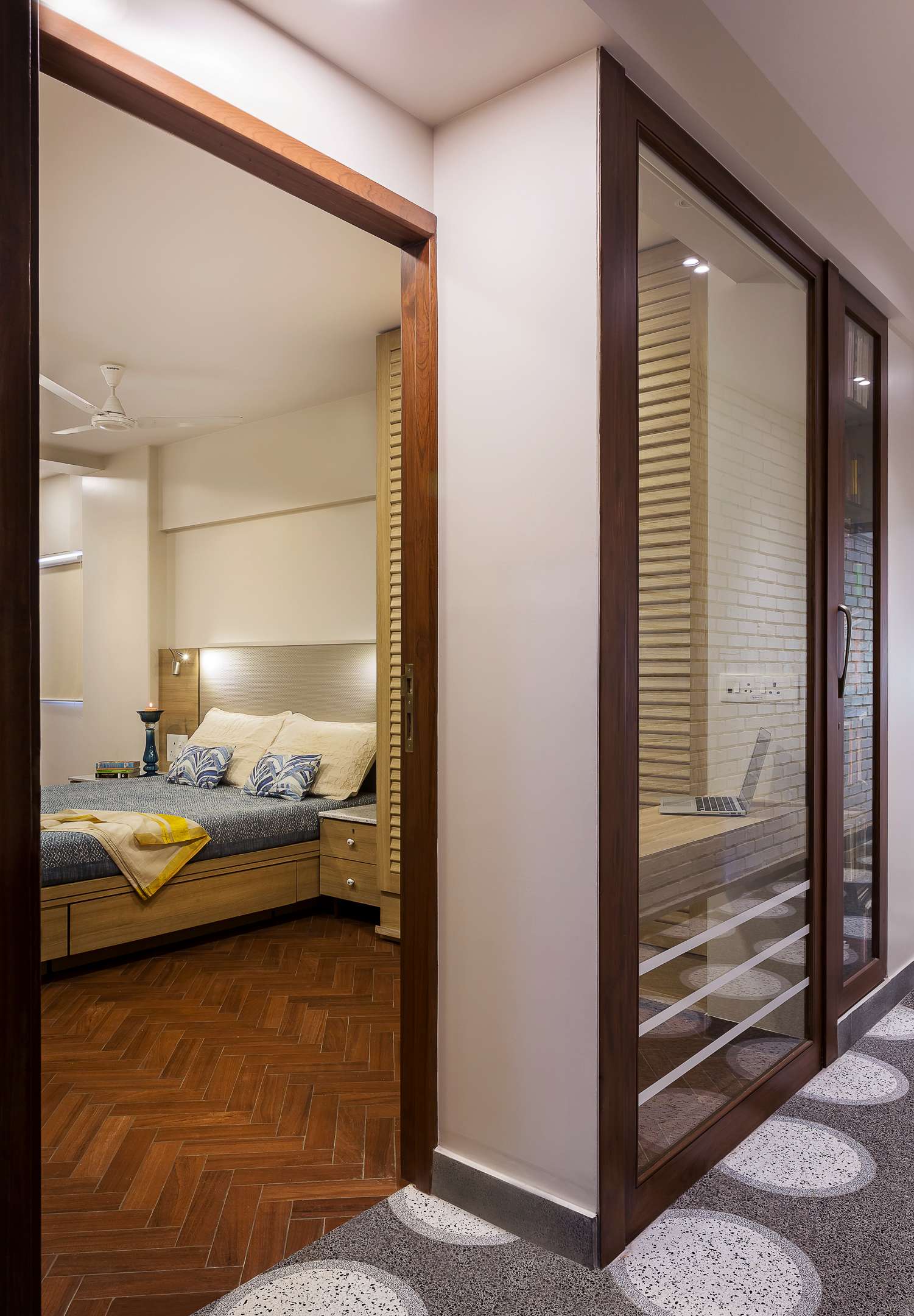 Nature-inspired preschool entrance with sculptural tree partitions and suspended green leaf ceiling panels.