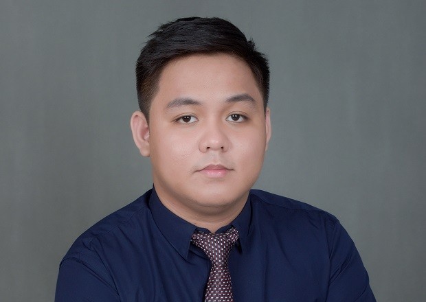 a man with a goatee smiles at the camera