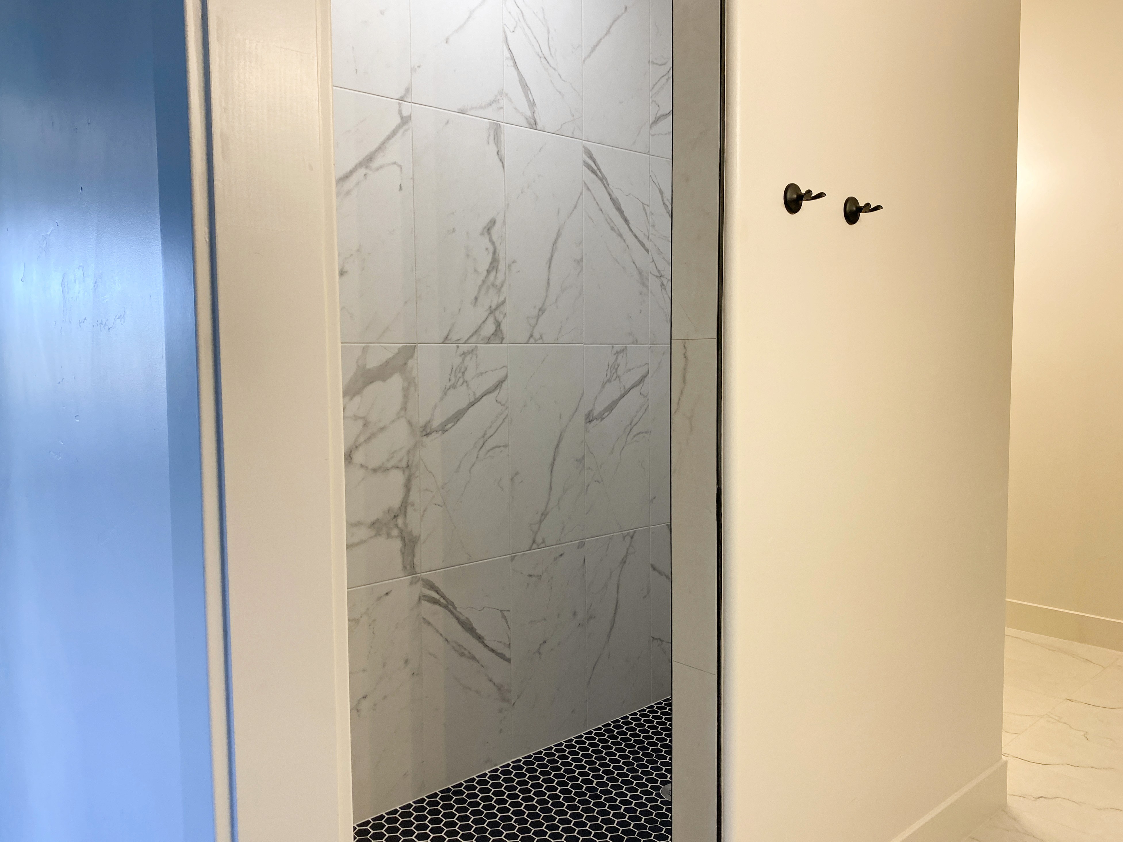Walk-in shower in primary bathroom of a Hurricane, Utah duplex with modern tile finishes
