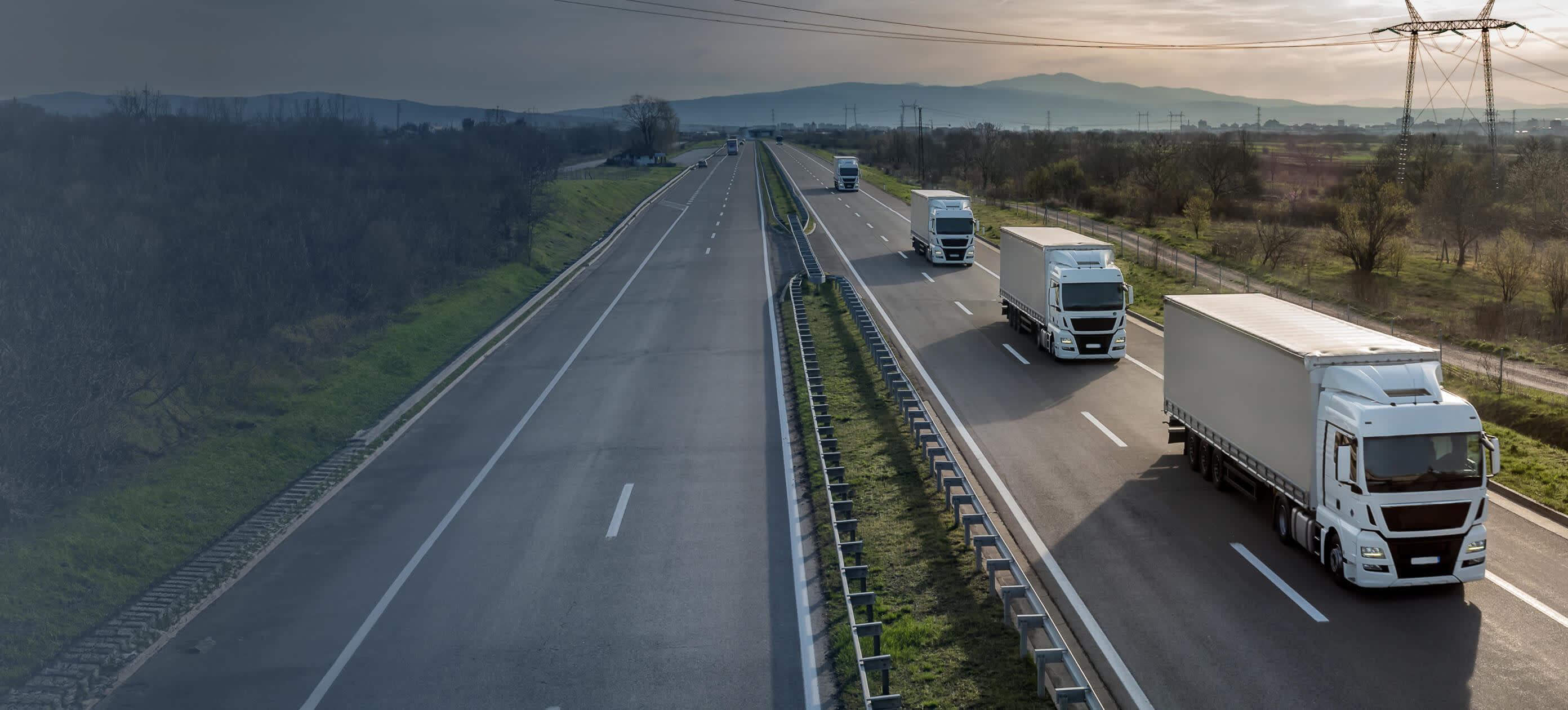 A busy Italian highway with cargo trucks representing the trucking industry's pivotal role in economic recovery.