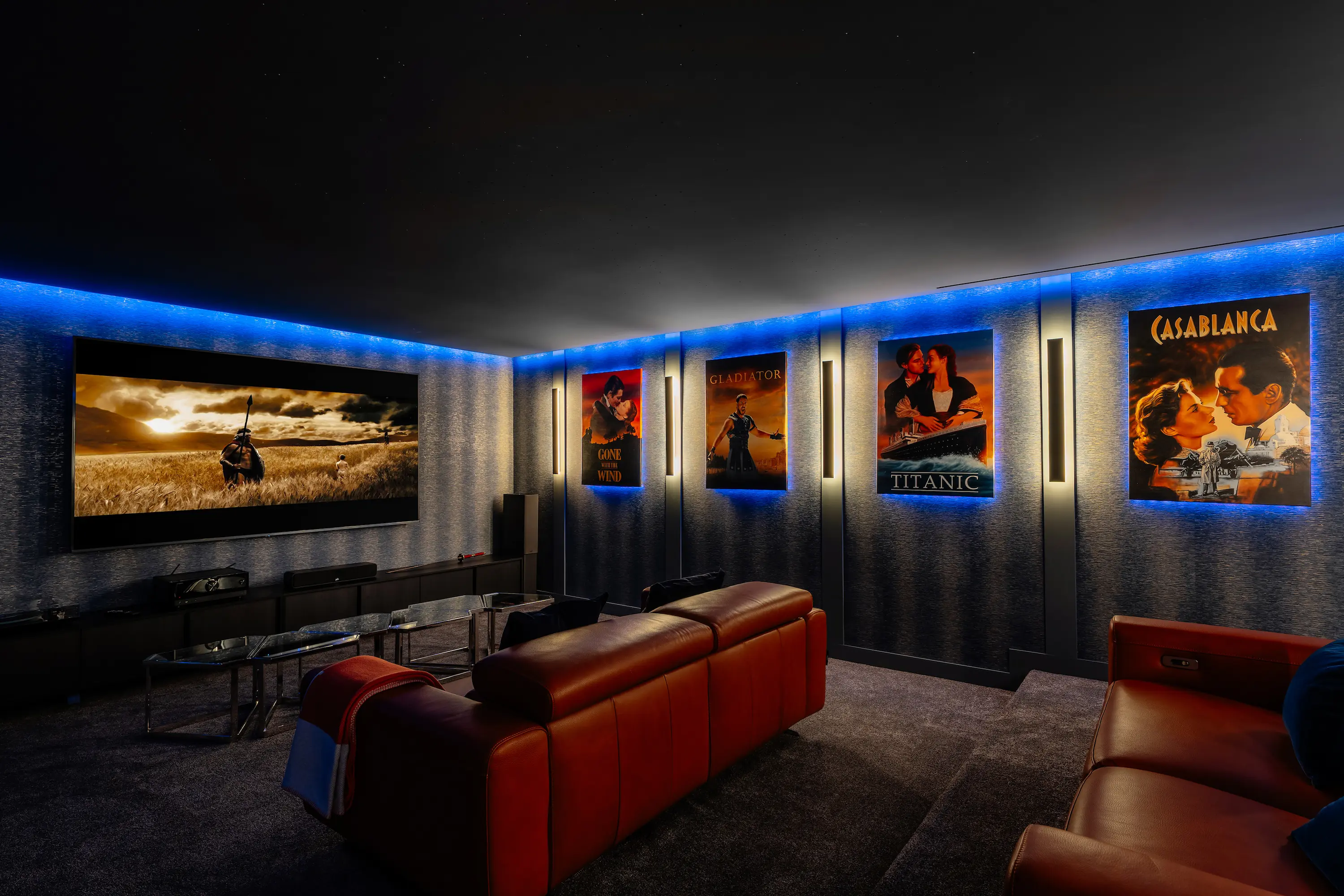 Villa Vista Marbella home cinema with leather recliners, acoustic wall panels, and ambient LED lighting