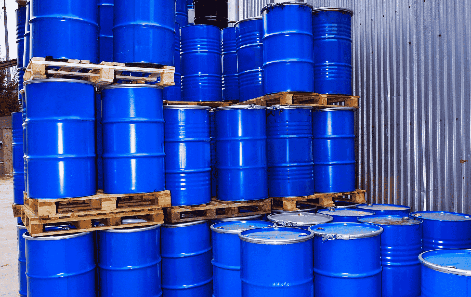 Yellow shipping container with a biohazard symbol being lifted by a crane.